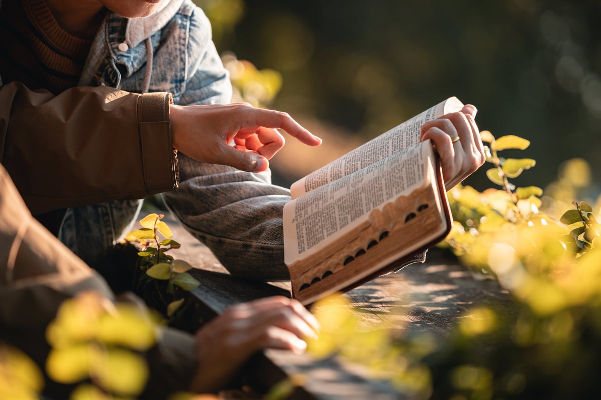 Two people reading the Bible and praying together